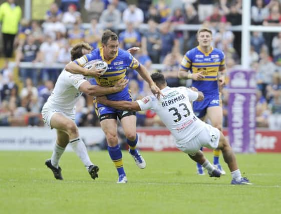 LONG ROAD BACK: Danny McGuire looks to break through the Widnes defence in July last year.