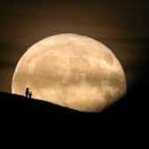 A Beaver Moon rises behind the Grade I listed St Michael's Tower on the top of Glastonbury Tor in 2017.