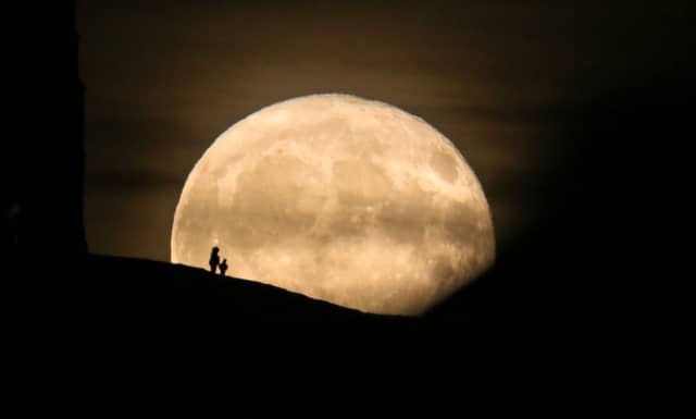 A Beaver Moon rises behind the Grade I listed St Michael's Tower on the top of Glastonbury Tor in 2017.