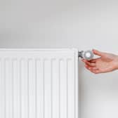 Adjusting thermostat.