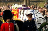 Soldiers accompany a gun carriage holding the coffin bearing the Queen Mother April 5, 2002.
