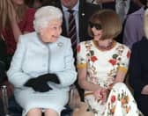 LONDON, ENGLAND - FEBRUARY 20:  Queen Elizabeth II sits next to Anna Wintour as they view Richard Quinn’s runway show before presenting him with the inaugural Queen Elizabeth II Award for British Design as she visits London Fashion Week’s BFC Show Space on February 20, 2018 in London, United Kingdom. (Photo by Yui Mok - Pool/Getty Images)