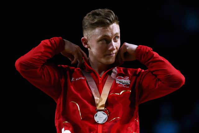 Nile Wilson of England poses during the medal ceremony for the Men's Parallel Bars Final during Gymnastics on day five of the Gold Coast 2018 Commonwealth Games at Coomera Indoor Sports Centre on April 9, 2018 on the Gold Coast, Australia.  (Photo by Dean Mouhtaropoulos/Getty Images)