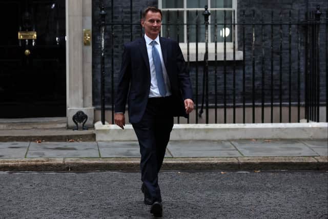 Britain's new Chancellor of the Exchequer Jeremy Hunt leaves 10 Downing Street in central London on October 14, 2022, after having a meeting with Britain's Prime Minister Liz Truss. - Newly appointed UK finance minister Jeremy Hunt is a mild-mannered political survivor who will require all of his considerable experience to calm an economy and government beset by chaos. (Photo by ISABEL INFANTES / AFP) (Photo by ISABEL INFANTES/AFP via Getty Images)