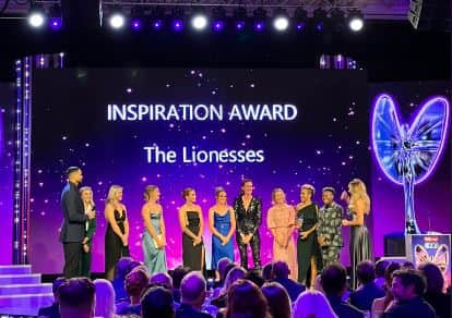 The Lionesses accepting their Inspiration Award from former boxer Nicola Adams, retired athlete Dame Kelly Holmes and cyclist Dame Laura Kenny, at the Pride of Britain Awards 2022. (Credit @PrideOfBritain Twitter)