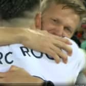 Jesse Marsch and Marc Roca embrace after Leeds United’s win at Liverpool.