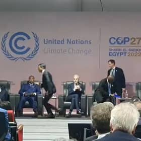 Prime Minister Rishi Sunak is seen running off the stage at an event at COP27 in Egypt.