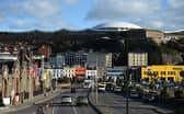 Cars travel by the seafront in St Helier, on the British island of Jersey