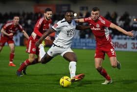 Lee Ndlovu of Boreham Wood takes a shot under pressure from Ryan Astley of Accrington Stanley during the Emirates FA Cup Third Round tie (Photo by Justin Setterfield/Getty Images)