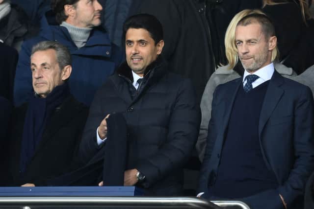 Former French president Nicolas Sarkozy (L) and PSG president Nasser Al-Khelaifi (C) are seen ahead of the UEFA Champions League football match between Paris Saint-Germain (PSG) and Bayern Munich (FC Bayern Muenchen) at the Parc des Princes in Paris, on February 14, 2023. (Photo by FRANCK FIFE / AFP)
