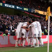 Leeds stars celebrate the side’s third goal as they climbed out the relegation zone on Saturday.