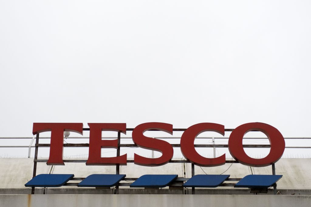 Tesco logo seen on the roof of one of its stores in London against the sky  as background Stock Photo  Alamy