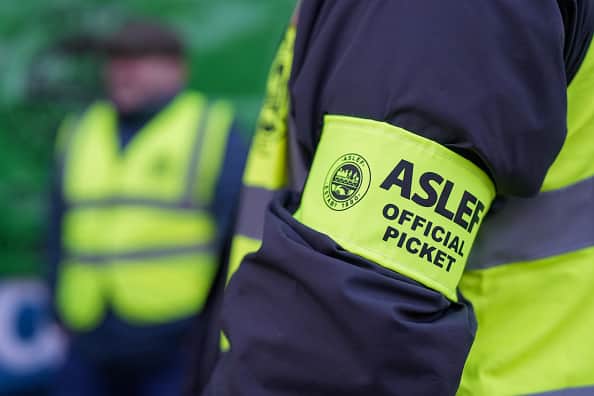 A striking train driver wears an Aslef armband on a picket line outside Leeds railway station during joint strike action by train drivers, teachers, university staff and civil servants, in Leeds, UK, on Wednesday, Feb. 1, 2023. (Dominic Lipinski/Bloomberg via Getty Images)