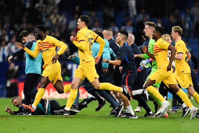 Players and staff of FC Barcelona flee the pitch (Photo by David Ramos/Getty Images)
