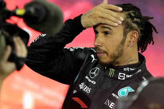 Second-placed Mercedes' British driver Lewis Hamilton reacts in the parc ferme of the Yas Marina Circuit after the Abu Dhabi Formula One Grand Prix on December 12, 2021 (Getty Images)