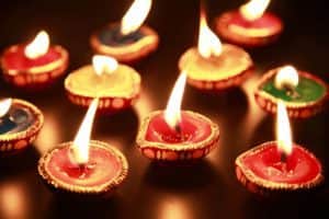 Beautiful traditional Diwali lamps with background effects of colorful lighting.