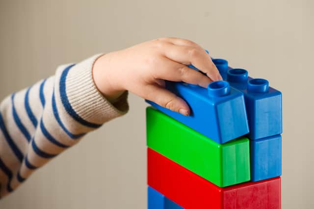 Child plays with building blocks.