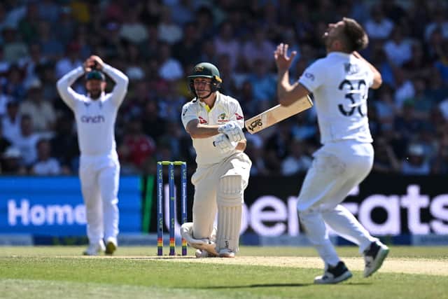 Australia's Marnus Labuschagne (C) plays a shot off the bowling of England's Mark Wood (R) on day two of the third Ashes cricket Test match between England and Australia at Headingley cricket ground in Leeds, northern England on July 7, 2023. (Photo by Paul ELLIS / AFP) / RESTRICTED TO EDITORIAL USE. NO ASSOCIATION WITH DIRECT COMPETITOR OF SPONSOR, PARTNER, OR SUPPLIER OF THE ECB (Photo by PAUL ELLIS/AFP via Getty Images)