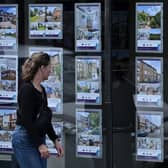 A pedestrians looks at residential properties displayed for sale in the window of an estate agents' in Windsor, west of London, on July 29, 2023. Britain's central bank, The Bank of England, is set to meet on August 3 to decide what level interest rates should be set at. The Bank of England has ramped up interest rates 13 times in a row to the current level of five percent in an attempt to dampen stubbornly-high inflation. (Photo by JUSTIN TALLIS / AFP) (Photo by JUSTIN TALLIS/AFP via Getty Images)