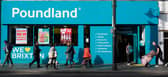 Shoppers walk past a Poundland shop in Brixton, south London.