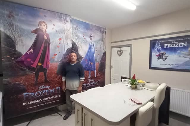 Paul with his 8ft tall Frozen banner at home. Picture by Showcase Cinemas