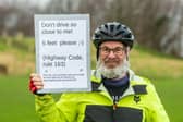 Tim Devereux, 75, has spent the last month asking drivers to keep their distance with an eye-catching sign attached to the back of his bike. Photo: James Hardisty.