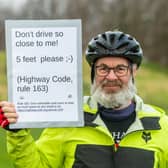 Tim Devereux, 75, has spent the last month asking drivers to keep their distance with an eye-catching sign attached to the back of his bike. Photo: James Hardisty.