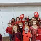 Youngsters at St Oswald's Primary School showed support for seven-year-old Luca Fox, who was born with complex heart defects, on Wear Red Day.