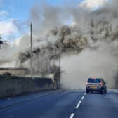 Huge clouds of smoke billow into the road near the scene of the fire close to Wesley Road in Armley. Photo: Melanie Robbins.
