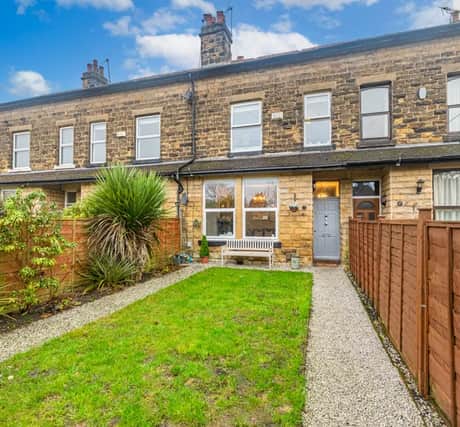 This gorgeous terraced home with gardens to the front and rear is on the market.