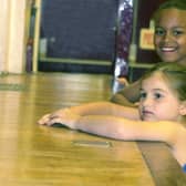 Dancers of the Helen Lamb Tap School were raising money for CARE International UK by dancing non-stop for two hours at Blackburn Hall in June 2000. Pictured are two girls watching the dancers on stage, while they take a break.