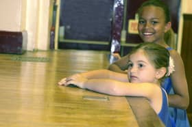 Dancers of the Helen Lamb Tap School were raising money for CARE International UK by dancing non-stop for two hours at Blackburn Hall in June 2000. Pictured are two girls watching the dancers on stage, while they take a break.