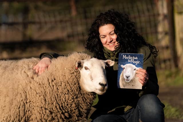 Grace Olson, therapist and author, with her new book Merlin Finds His Magic based on therapy sheep Merlin. Photo: Submitted