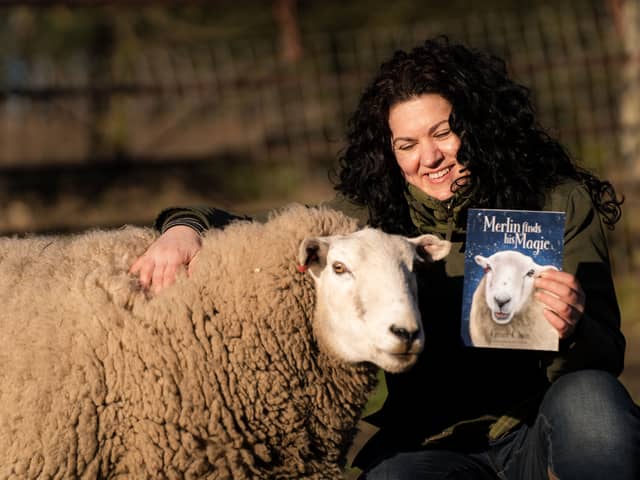 Grace Olson, therapist and author, with her new book Merlin Finds His Magic based on her therapy sheep Merlin. Photo: Submitted