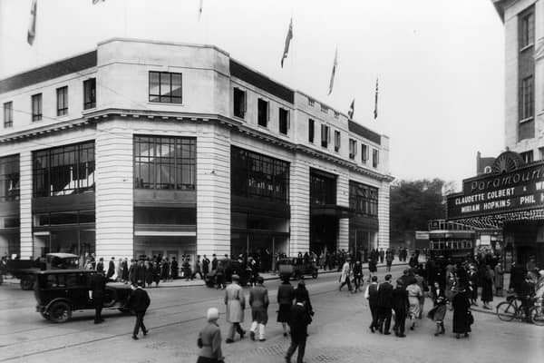 The Headrow at the junction with New Briggate, showing Lewis's department store on the left, possibly at the time of its opening on September 17, 1932 as the streets are lined with people and flags decorate the top of the store. On the right is the Paramount Cinema, later The Odeon, with films starring Claudette Colbert and Miriam Hopkins the main attraction.