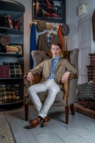 Josh wears: Blue Colours & Sons at Abraham Moon printed shirt, £70; Abraham Moon beige blazer, £299; silver and Whitby Jet limited edition Commemorative Dracula pendant, £185, W Hamond; jeans, model's own.Wool/leather wingback chair from Vintage Sofa Company, £1,599, at Abraham Moon. Picture James Hardisty. Styling and shoot production: Stephanie Smith