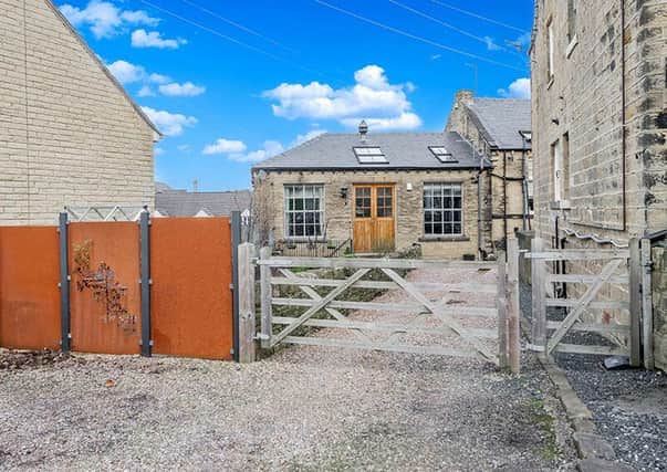 This former industrial glass company converted into a semi-detached home is on the market.