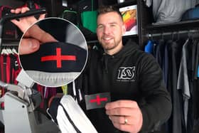 Director Grant Walters at The Sports Shop in Kingswinford show off their St George's Cross transfer to apply to new England kit. A sports shop is selling St George’s Cross iron-on transfers for £4.95 - so fans can cover the controversial design on the new England football shirt. 