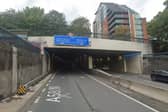 The A58 was closed in both directions after a man was stood on the wrong side of the Great George Street footbridge.