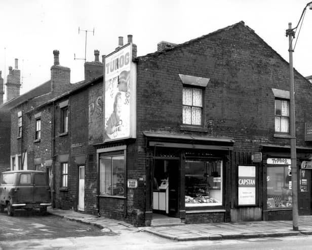 Seamer Street at the junction with Armley Road, houses number from the left edge 6, 4 and 2. Fronting onto Armley Road are two shops, number 192, which appears to be a butchers and adjacent, number 190, grocers. A sign for S. Morris and Sons Furniture Makers points in the direction of Pickering Street, far right. Pictured in February 1964.