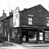 Seamer Street at the junction with Armley Road, houses number from the left edge 6, 4 and 2. Fronting onto Armley Road are two shops, number 192, which appears to be a butchers and adjacent, number 190, grocers. A sign for S. Morris and Sons Furniture Makers points in the direction of Pickering Street, far right. Pictured in February 1964.