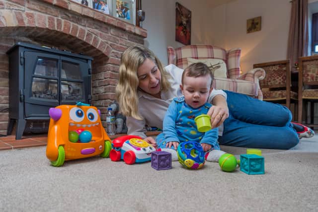Mrs Jenkyns pictured at home with son Clifford in 2018. Photo: James Hardisty.