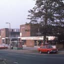 Meanwood Shopping Centre situated on Green Road, with Malcolm’s Bargain Stores prominent. A bus shelter is seen in front. Pictured in 1977.