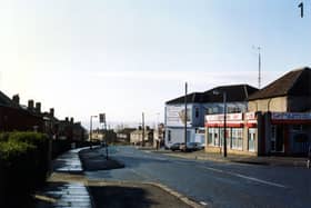 Looking south along Osmondthorpe Lane, showing A.J.R. Superstores, general grocer and off licence, at no. 84 on the right. Beyond this is Timmerdales ice cream factory with an advertising hoarding on the wall. The junction with Ings Road follows this, and semi-detached housing can be seen further down and on the left of the photo from January 1991.