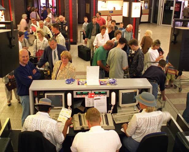 Leaving on a jet plane. Holidaymakers check-in for a flight to Palma in June 1996.