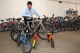 Auctioneer Paul Cooper with some of the high-value bikes going under the hammer.