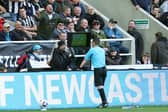 Tony Harrington checks the Video Assistant Referee screen during the Premier League match between Newcastle United and Sheffield United at St. James Park
