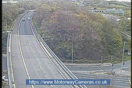 A woman has been brought to safety after she was spotted on the wrong side of the railings on a bridge over the M621. Photo: motorwaycameras.co.uk.