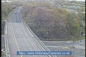 A woman has been brought to safety after she was spotted on the wrong side of the railings on a bridge over the M621. Photo: motorwaycameras.co.uk.