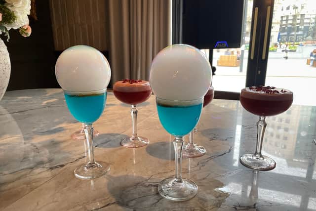 A selection of fruity cocktails were served on arrival, including a electric blue curacao cocktail that was presented with an enormous bubble of fragrant rosemary. Photo: National World.